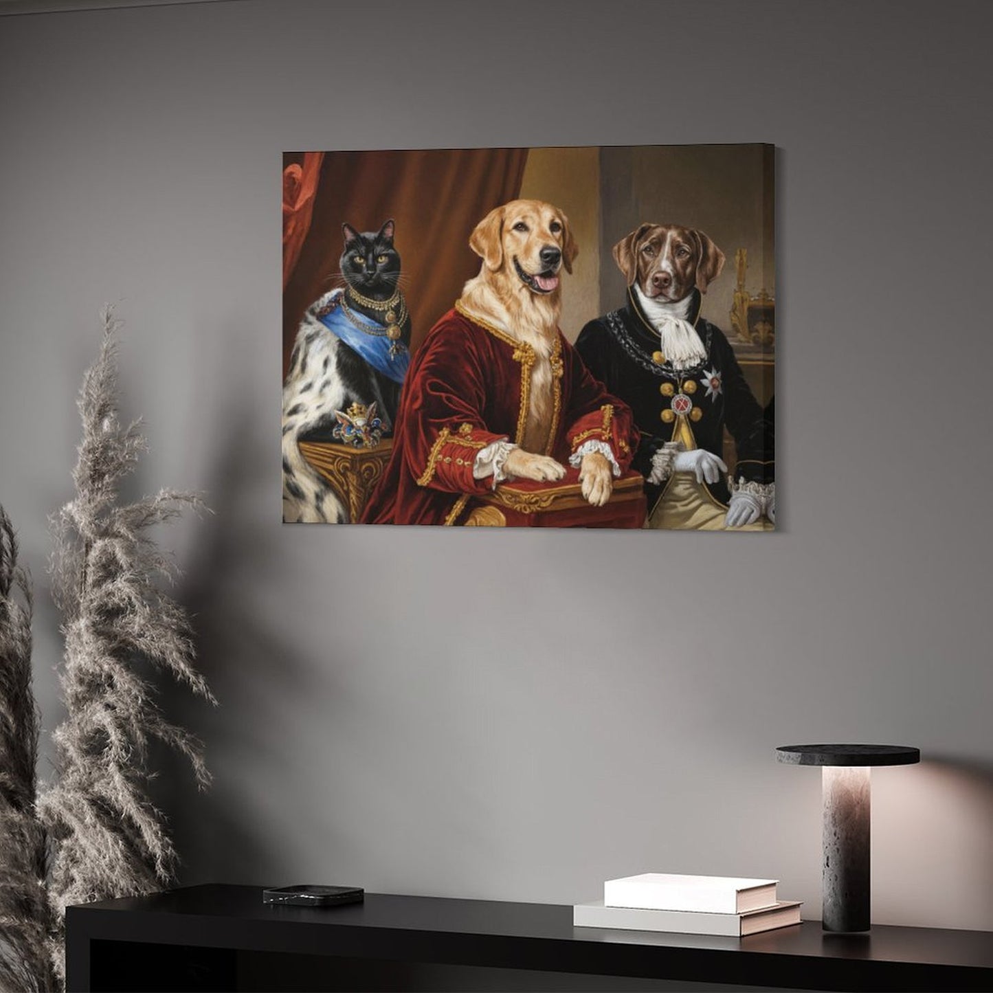 Artistic depiction of a cat and two dogs in regal attire on a gray wall above a desk.